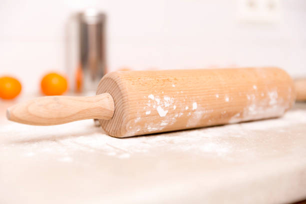 istock Making gingerbread cookies for Christmas in kitchen. Woman's hands, dough roll, gingerbread cutter, tangerines 896358886