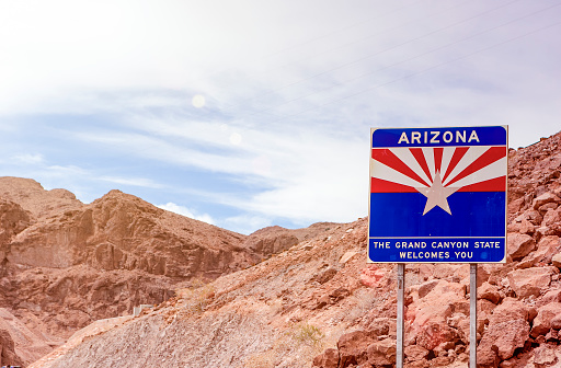 Arizona State Border Highway Sign Against Sky Blue Background. Light Effect Used. Horizontal Image Composition