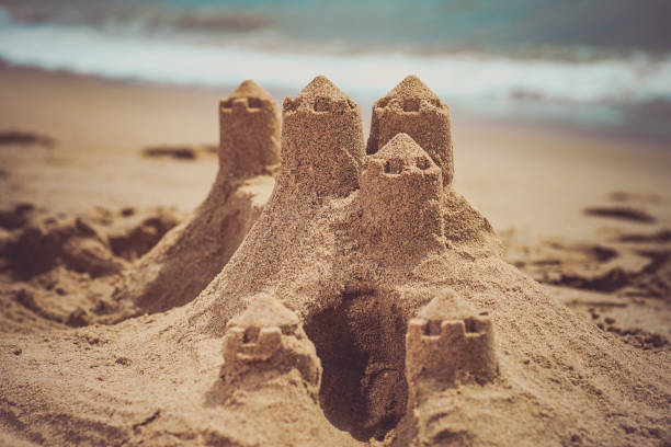 istock Sand castle standing on the beach. Travel vacations concept. 896368342