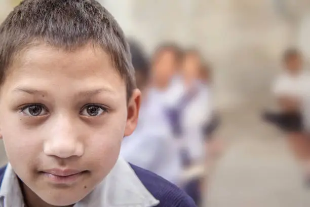 Photo of Portrait of smiling elementary Indian/Asian school Boy looking at camera.