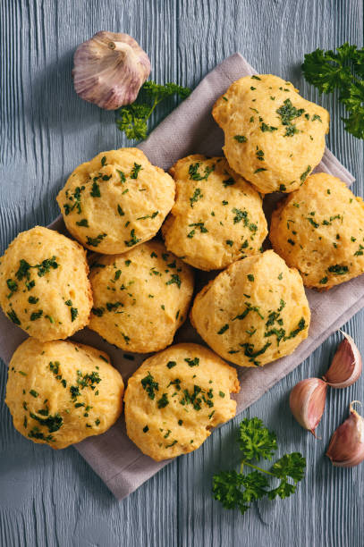 istock Homemade garlic cheese biscuits on wooden background. 896372256