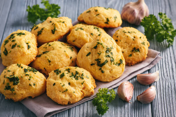 istock Homemade garlic cheese biscuits on wooden background. 896372258