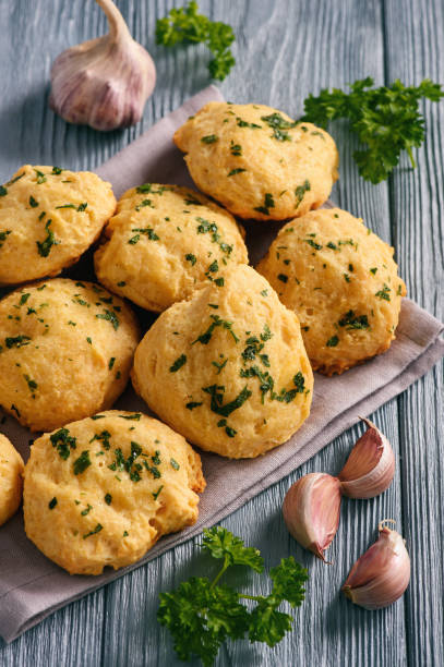 istock Homemade garlic cheese biscuits on wooden background. 896372286
