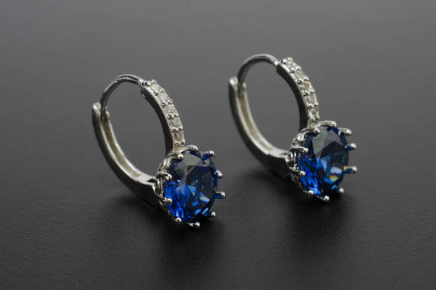 istock silver earrings with diamonds and sapphires isolated on black 896375160