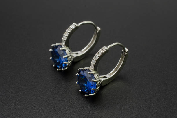 istock silver earrings with diamonds and sapphires isolated on black 896375168