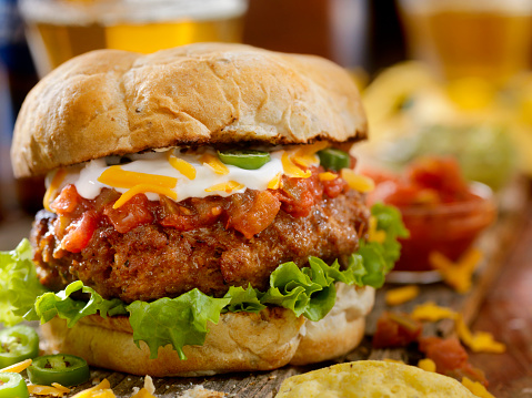 The Taco Seasoned Burger with Salsa, Sour Cream, Guacamole, Cheddar Cheese and Jalapenos