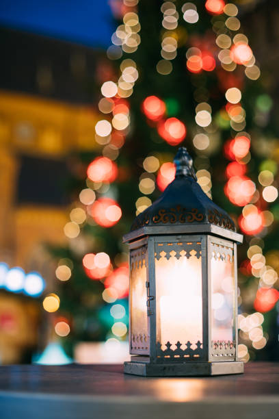 istock Christmas Lantern With Burning Candle On Bright Blurred Christmas Xmas Lights Background 896378162