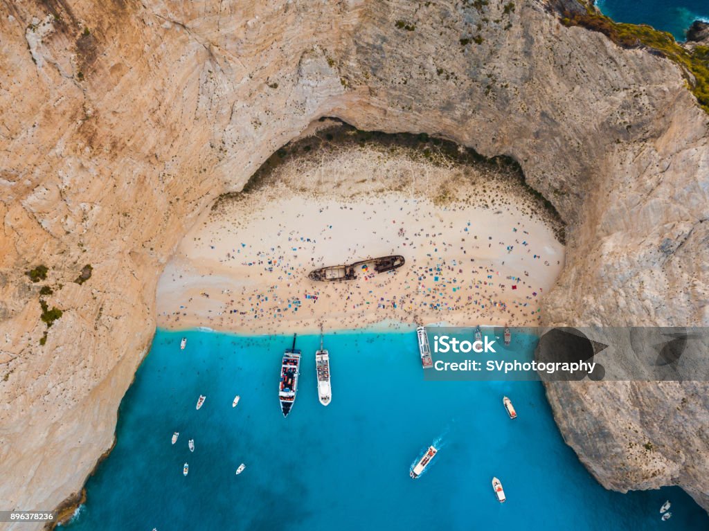 View from the air on the Well Known Navagio Shipwreck Beach View from the air on the Well Known Navagio Shipwreck Beach full of people, Greece Shipwreck Beach - Zakynthos Stock Photo