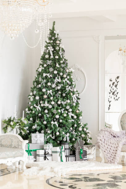 istock Christmas morning. classic apartments with a white fireplace, decorated tree, bright sofa, large windows 896380430