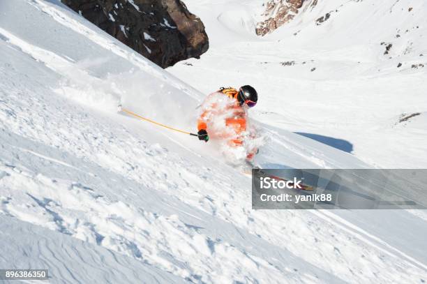 Ski Athlete In A Fresh Snow Powder Rushes Down The Snow Slope Stock Photo - Download Image Now