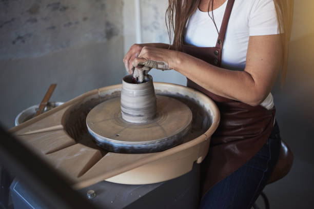 istock Creative artisan shaping wet clay on a pottery wheel 896386614