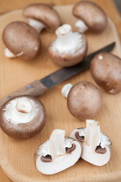 istock Mushrooms on cutting board with kitchen knife 896387374