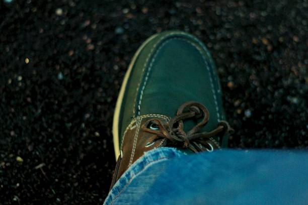 istock The green and shabby moccasins with a leather lace. 896391778
