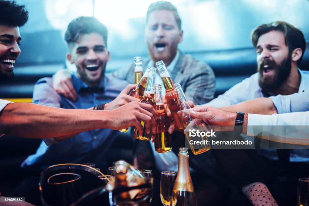 Good times ! Group of men toasting with beer Young Men Stock Photo