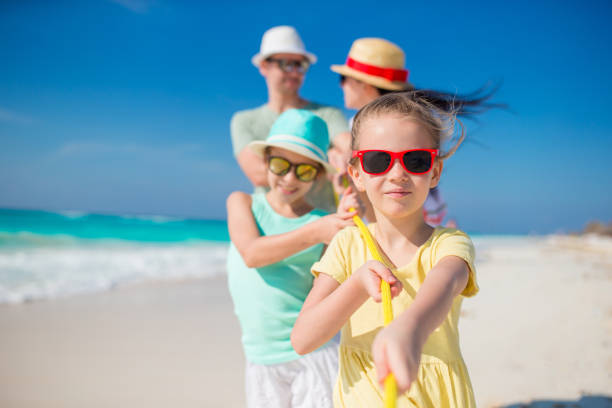 istock Family of four on beach vacation 896392182