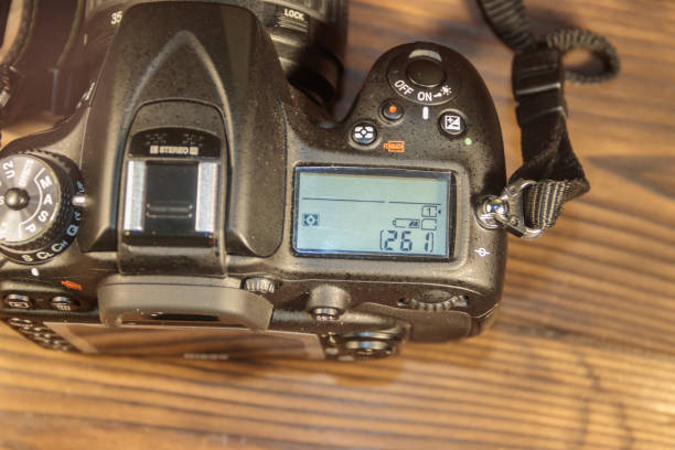 istock Professional digital photo camera on wooden background close-up 896395042