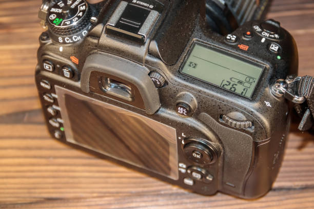 istock Professional digital photo camera on wooden background close-up 896395044