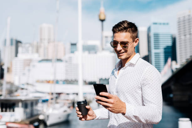 Coffee break at yacht club for successful businessman Portrait of handsome young Australian man with light brown hair and blue eyes. Businessman going for a coffee break to yacht club elite stock pictures, royalty-free photos & images