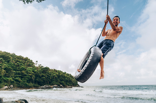 Tire swing at tropical beach