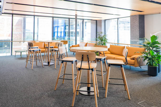 istock Meeting area in a modern creative coworking office space with couch, sofa, bar stools, leaner tables, carpet. No people, modern building interior. 896403186
