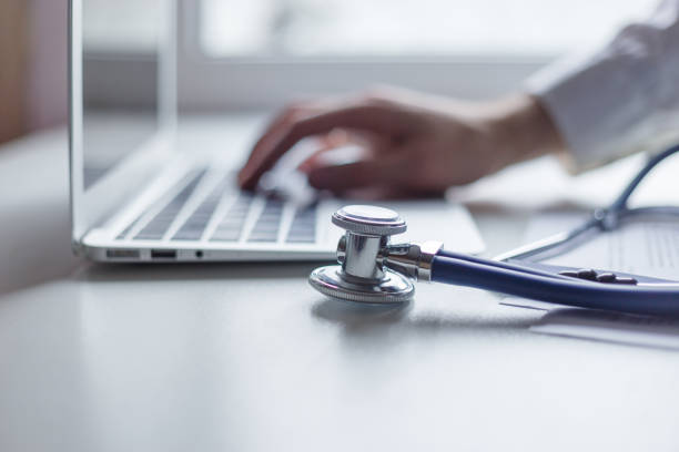 istock Doctor working with laptop computer in medical workspace office. Focus on stethoscope 896405840