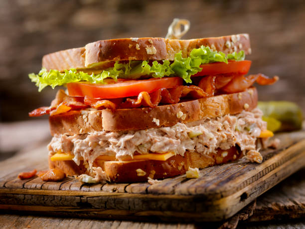 thunfischsalat, blt, clubhaus sandwich - cheese focus on foreground on top of portion stock-fotos und bilder