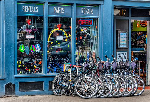 Portland, Oregon,USA - October 8, 2016: A bike shop store front with multiple bikes lined up on the sidewalk in downtown Portland, Oregon