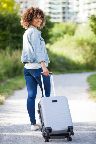istock Woman with Carry on Luggage 896418740