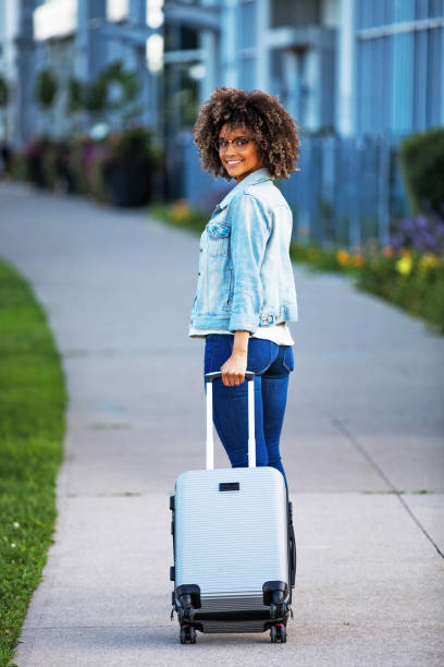 istock Woman with Carry on Luggage 896418744