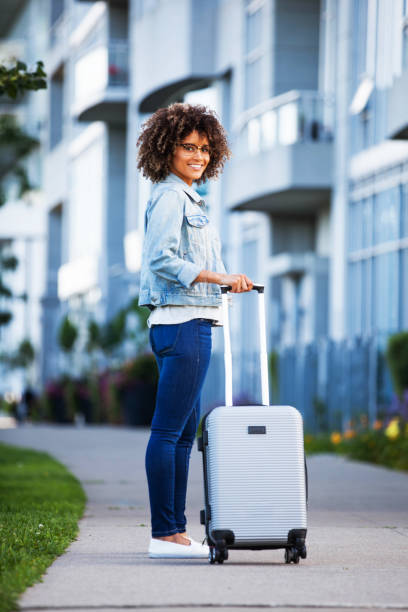istock Woman with Carry on Luggage 896418760