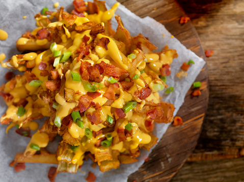 Loaded Blooming Onion with Fries, Cheese Sauce, Green Onion and Bacon