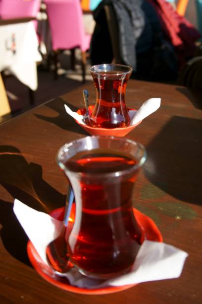 istock Two tea glass on table with two tea spoon near the glasses 896427064