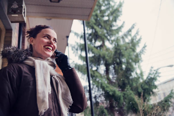 istock Woman on mobile phone getting out in winter. 896427324