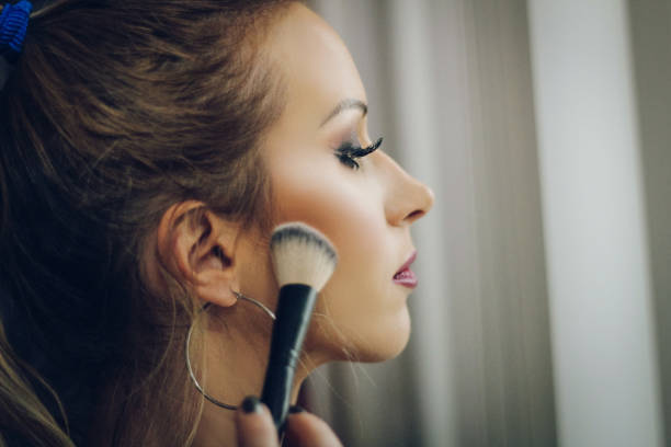 istock Woman holding makeup brushes 896435960