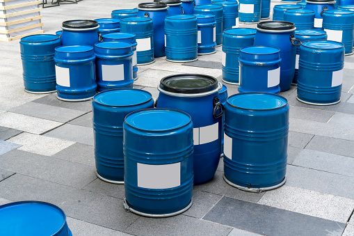 Blue barrels bottom up for tables and chairs. Outdoor or street furniture