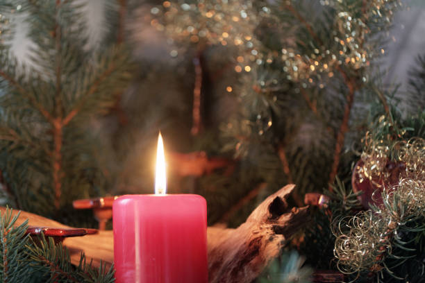 istock Red candle of an Advent wreath with fir branches. 896439308