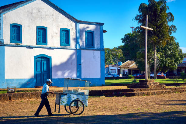 Popcorn seller walks with his cart selling popcorn in front of the church. stock photo