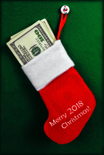 istock Christmas stocking full of hundred-dollar bills 896450388