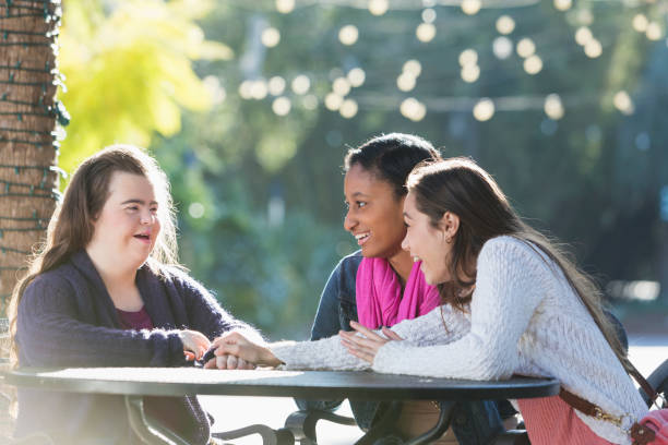istock Three teenage friends talking, one with down syndrome 896455930