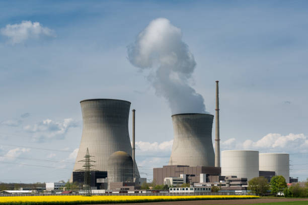 istock Nuclear power plant with yellow field and big blue clouds. 896457074