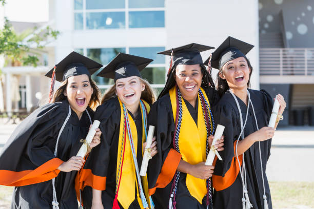 istock Four young women graduating from high school or college 896458328