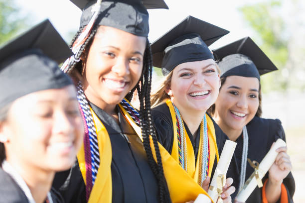 istock Four young women graduating from high school or college 896458436