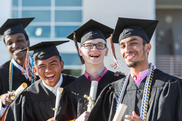 istock Four young men graduating from high school or college 896458494