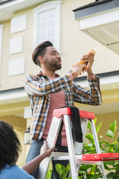 istock Couple doing home repairs outside house 896458622