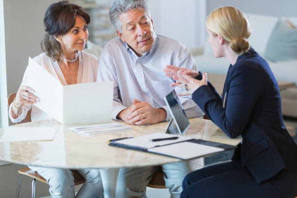 istock Senior couple talking with financial advisor 896458638