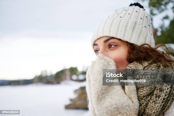 Pensive Woman Blowing On Hands In Winter Stock Photo - Download Image Now - Women, Cold Temperature, Nose