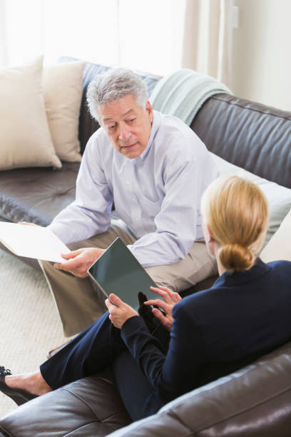 istock Businessman meeting with woman, sitting on sofa 896458848