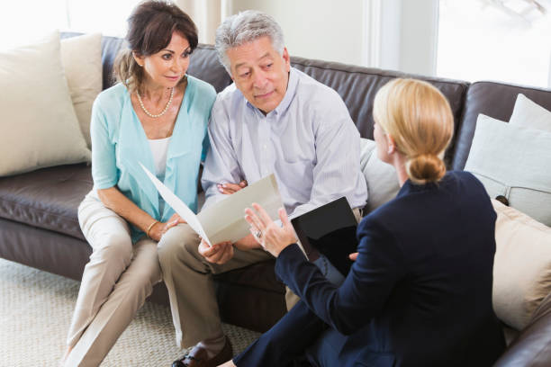 istock Senior couple talking with financial advisor 896460766