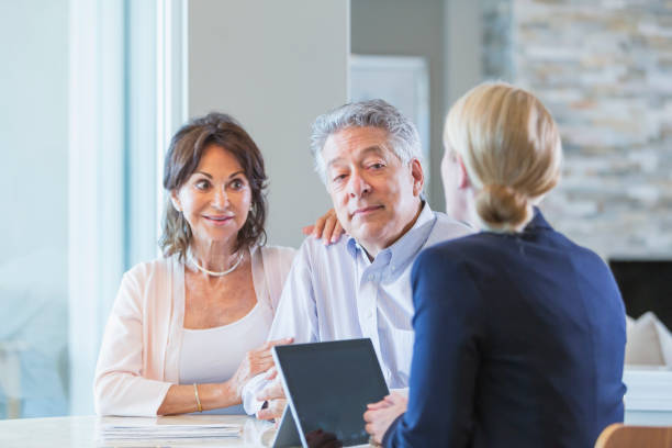 istock Senior couple talking with financial advisor 896460930