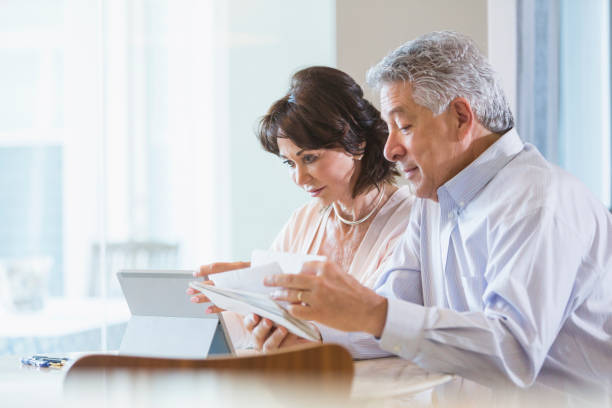 istock Senior couple paying bills online 896461200